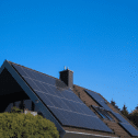 Hausdach mit Solarpaneelen bei klarem Himmel